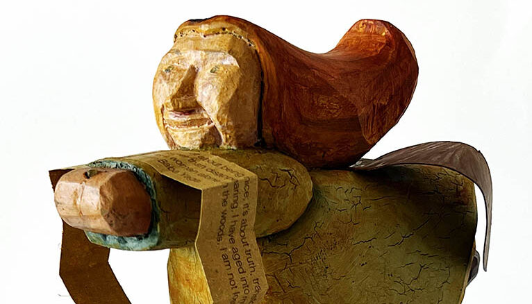 Baba Yaga
Baba Yaga embodies powerful, independent femininity outside patriarchal norms, representing wild nature, intuition, and boundary-setting; she's a complex archetype who tests heroines, demanding self-reliance and rejecting submissive roles, often linked to ancient earth goddesses feared by rising male-dominated societies. Her connection to the wild, her refusal to be simply "good" or "evil," and her role as a powerful force in folklore make her a symbol for re-evaluating womanhood beyond traditional, exploitable models. She controls her own domain, and operates by her own rules, unafraid of male authority.She challenges the "selfless, ever-caring" woman trope by being terrifying, consuming, or demanding, forcing growth through fear and introspection.Her deep link to the forest, often seen as an ancient Earth goddess figure, resonates with ecofeminism, highlighting the inseparable bond between women and the natural world. She empowers heroines through intense trials, forcing them to develop inner strength, cunning, and intuition (like using a magic doll), making them worthy and independent.

The text in the book cascading from Baba Yaga reads:
I am Baba Yaga. I help some and devour others. I rage without apology, enjoy solitude without shame, and wield power without justification. I do not exist to model virtue—I exist to endure.
I challenge the cultural demand that women—especially older women—exist primarily as caregivers. I am not nurturing or gentle, and I refuse to soften the wisdom I offer. 
It’s not about being nice; it’s about truth, transformation, and survival. Rather than disappearing, I have aged into myself as an old, powerful, sharp-tongued woman, uninterested in approval. I do not ask to be liked, saved, or redeemed.
As a woman alone in the woods, I am not lost—I am at home.
I am Baba Yaga.
Baba Yaga is a found wooden folk sculpture, 11”x8”x4”. It was minimally repainted and a book, in two parts, was added, 1"x3/4” each, closed and 1”x11” each, open. A braided leather thong holds the book closed.